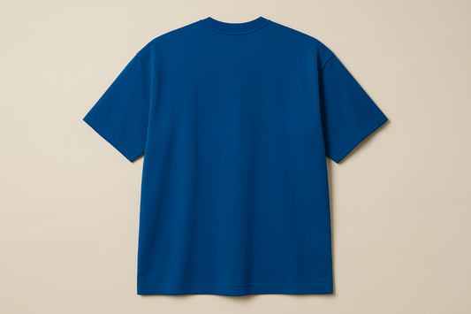 Professional e-commerce product photography of an oversized royal blue crew neck t-shirt displayed without a model, showing the back view against a neutral beige background with studio lighting