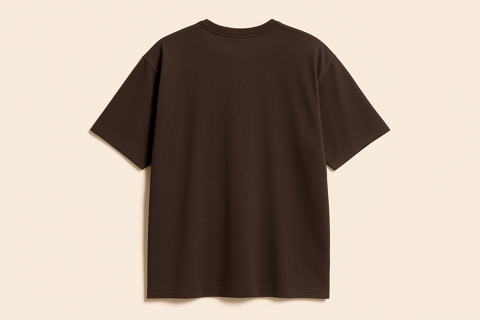 Professional e-commerce product photography of an oversized dark brown crew neck t-shirt displayed without a model, showing the back view against a neutral beige background with studio lighting
